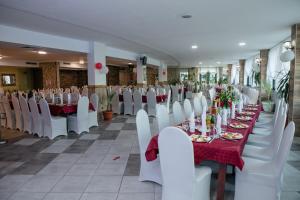 a row of tables and chairs in a banquet hall at Hotel Caesars Palace in Sunny Beach