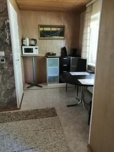 a small kitchen with a table and a microwave at Apartment by the park in Imatra