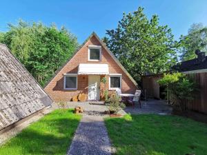 a brick house with a patio and a yard at Haus am See in Hermannsburg