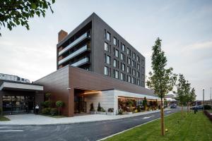 a large building on the side of a street at Qosmo Brasov Hotel in Braşov