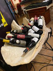 a bunch of wine bottles sitting in a basket at ALCAMAR Alquiler de Habitaciones con cocina y baño compartido y balcón con vista al mar! in Alcalá