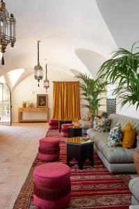 a living room with a couch and red ottomans at Soho Boutique Castillo de Santa Catalina - Adults Recommended in Málaga