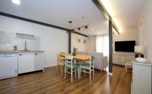 a kitchen and dining room with a table and chairs at -La Olmeda- La Casona del Zoilo in El Burgo de Osma +4 photos