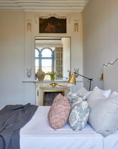 a bedroom with a white bed with pillows on it at Soho Boutique Castillo de Santa Catalina - Adults Recommended in Málaga