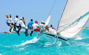 a group of people jumping off a sailboat in the ocean at Da Sugar House in Georgetown