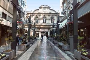 a building with a fountain in the middle of a street at Kastalia Living Thessaloniki in Thessaloniki