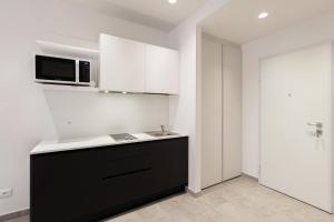 a kitchen with a black and white counter and a microwave at Marsala, Bologna by Short Holidays in Bologna