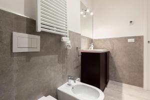 a bathroom with a sink and a toilet and a mirror at Marsala, Bologna by Short Holidays in Bologna