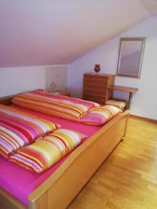 a bedroom with two beds with colorful blankets at Ferienwohnung Rosemarie Wagner in Grafenau