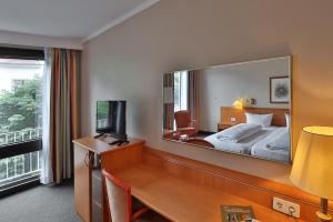 Postel nebo postele na pokoji v ubytování Hotel Quellenhof