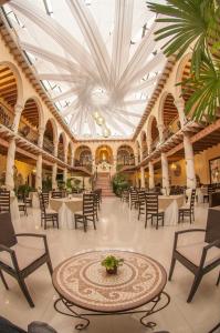 a banquet hall with tables and chairs in a building at Centro Hotel Villa las Margaritas in Xalapa