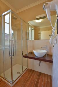 a bathroom with a glass shower and a sink at Albergo San Martino in Lucca