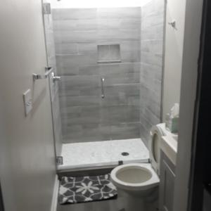 a bathroom with a shower with a toilet and a sink at The In-town spot by Beltline in Atlanta