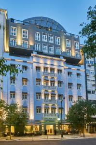 a large white building with lights on it at PortoBay Marquês in Lisbon