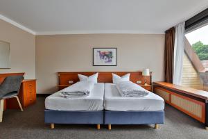 Postel nebo postele na pokoji v ubytování Hotel Quellenhof
