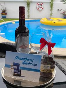 eine Flasche Wein und ein Schild auf dem Tisch in der Unterkunft Ferienhaus Anita nahe Timmendorfer Strand, Travemünde und Lübeck in Sereetz