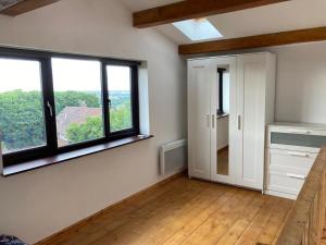 an empty room with a large window and a door at Casa in Gateshead