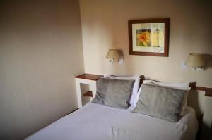 a bedroom with a white bed with two pillows at Aldea Andina Hotel San Carlos de Bariloche in San Carlos de Bariloche +15 photos