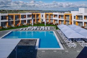 a swimming pool with lounge chairs and a hotel at LetooteL Hotel in Blagoveshchenskaya