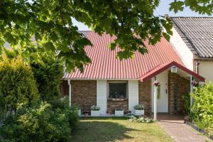 a brick house with a red roof at Baltiq Spot Rewa in Rewa