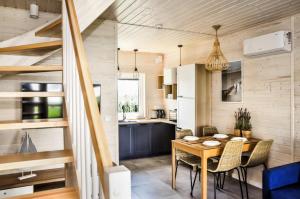 a kitchen and dining room with a table and chairs at Błękitny Kopań in Kopań