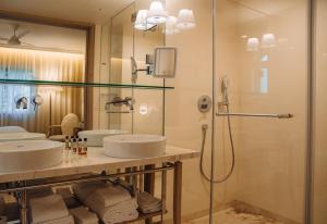 a bathroom with three sinks and a shower at Vila Alba Resort in Carvoeiro