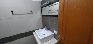 a small bathroom with a sink and a toilet at Studenti Studio's in Tirana
