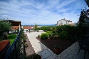 een uitzicht op een huis en een tuin met planten bij Sea Star Apartment in Koper