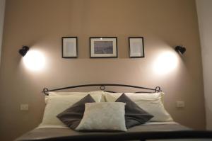 a bedroom with a bed with three pictures on the wall at Casa Jumasca in Massa Lubrense