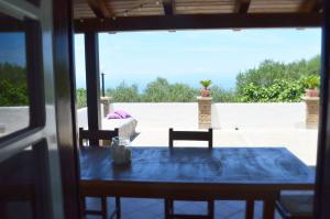 a table and chairs with a view of a patio at Casa Jumasca in Massa Lubrense