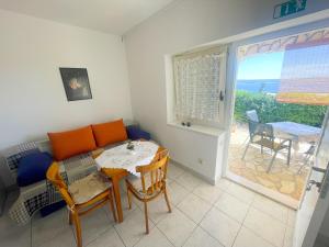 a living room with a table and a table and chairs at Apartments Kate in Dramalj
