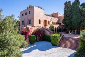 a building with stairs and flowers in front of it at Soho Boutique Castillo de Santa Catalina - Adults Recommended in Málaga