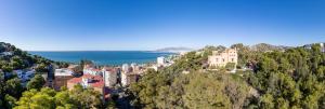 a town on top of a hill next to the ocean at Soho Boutique Castillo de Santa Catalina - Adults Recommended in Málaga