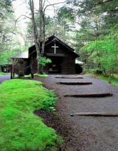 a small chapel with a cross on the front of it at Kyu Karuizawa Hotel Otowa No Mori in Karuizawa +80 photos
