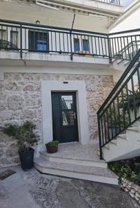 a house with a black door and stairs at Manda Gradac in Gradac