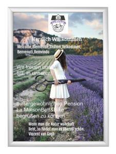 a poster of a girl holding a tennis racket in a lavender field at La Maison Bett & Bike in Pritzwalk
