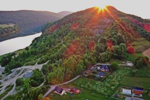 an aerial view of a hill with the sun setting on it at Leśniakówka 693-664-683 in Solina