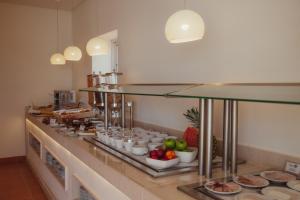 a buffet line with food on display in a restaurant at Vila Alba Resort in Carvoeiro