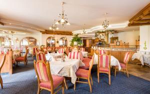 ein Restaurant mit Tischen und Stühlen in einem Zimmer in der Unterkunft Hotel Moserhof in Reutte