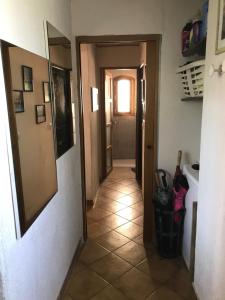 a hallway of a room with a door and a tile floor at Chambre climatisée avec sdb privée dans une villa avec piscine ouverte d'avril à mi octobre in Marseille