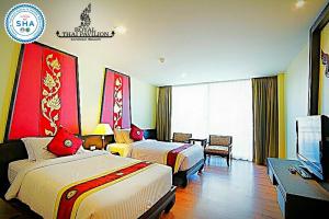 Postel nebo postele na pokoji v ubytování Royal Thai Pavilion Jomtien Hotel