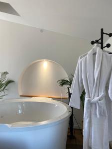 a bathroom with a white tub and a mirror at 04A2 - Paradise Love In Provence - le loft étoilé - spa privatif in Reillanne