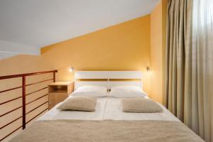 Posteľ alebo postele v izbe v ubytovaní Apartmani Toplice