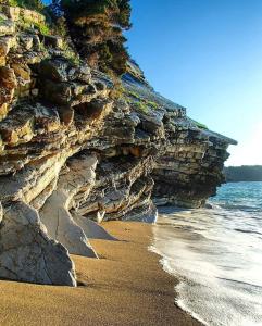 a beach with rocks and the water and the ocean at Villas Ermali in Ksamil