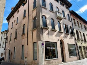 a large building with a store in front of it at SANTA CATERINA: charming apartment TREVISO in Treviso