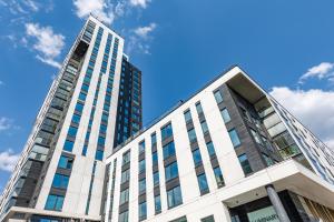 a tall building with a blue sky in the background at Brand-new City Home 33m2 in Tampere