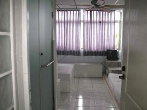 a small room with a bed and a window at Art Taiwan Homestay in Shunan +48 photos