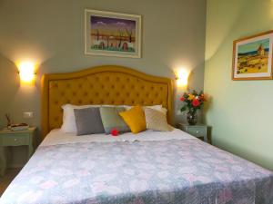 a bedroom with a large bed with two lamps at Agriturismo Fattoria Corte Roeli in Malalbergo