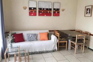 a living room with a couch and a table at Des vacances de rêve in Fréjus +12 photos