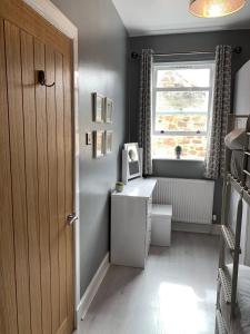 a small room with a desk and a window at Skippers Retreat (with free doorstep parking) in North Berwick